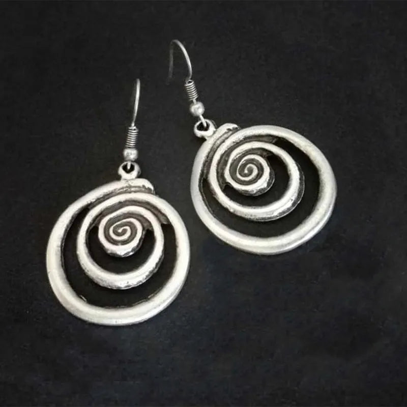 Silver geometric spiral earrings with distressed finish measuring 2.6 by 5 centimetres