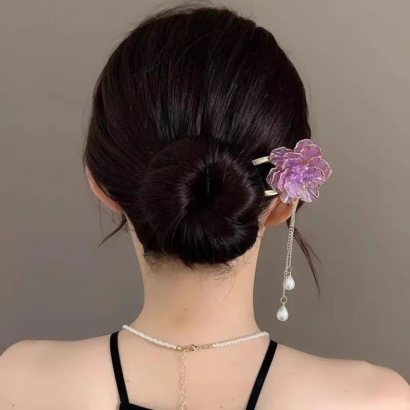 Close-up of a retro-style U-shaped alloy hairpin with a detailed peony flower and tassel design, shown in a purple electroplated finish.