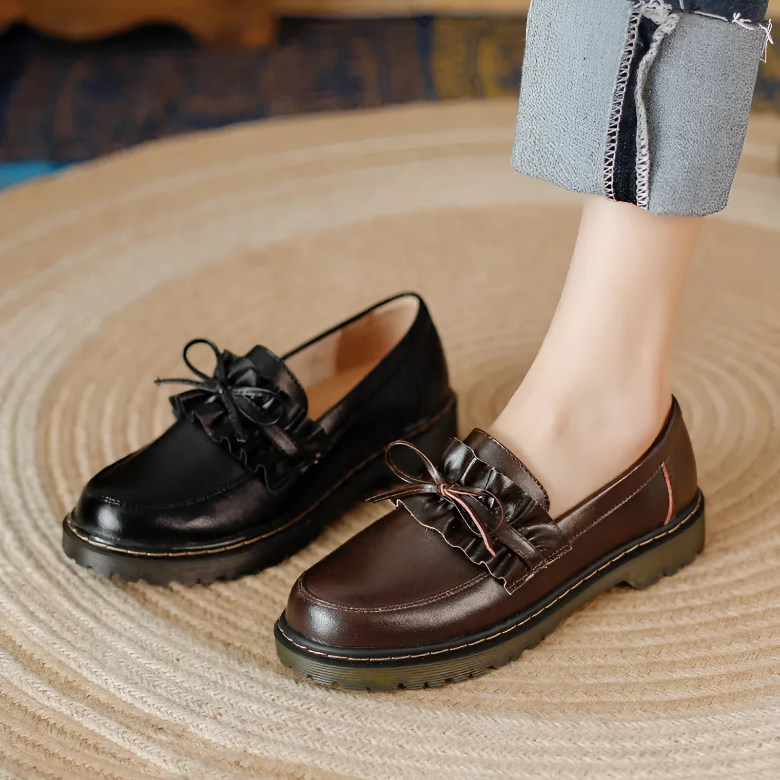 Women's black round-toe leather shoes with a chunky flat heel and lace-up front.