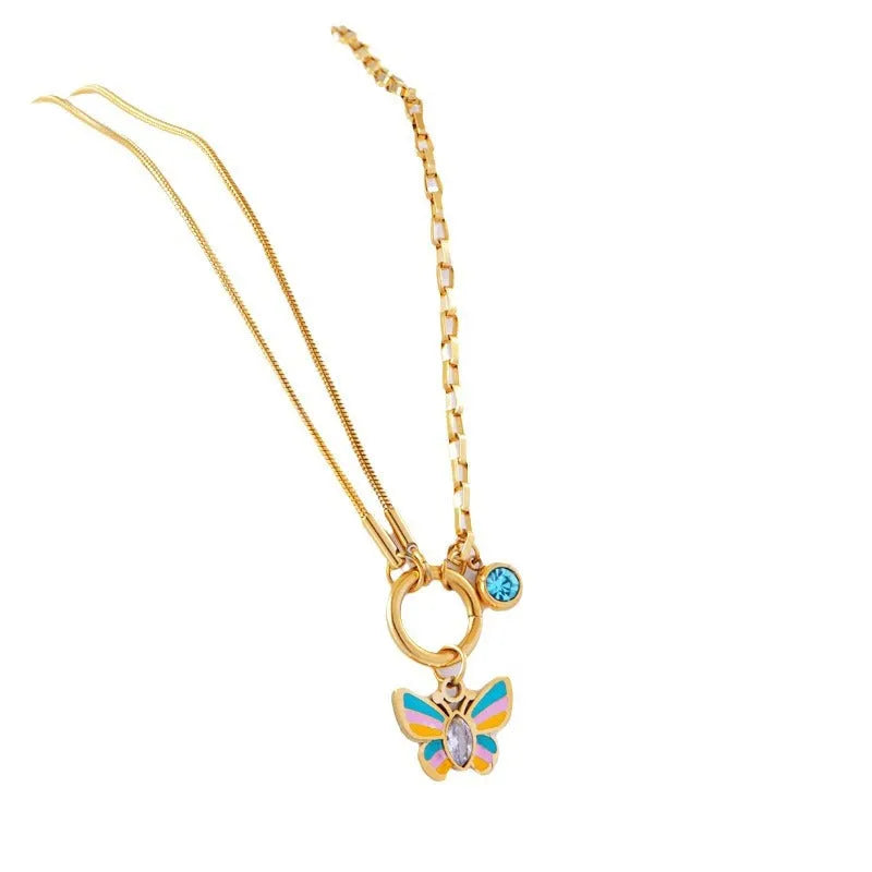Gold-coloured titanium steel butterfly jewellery set with necklace and bracelet showing epoxy resin pendants