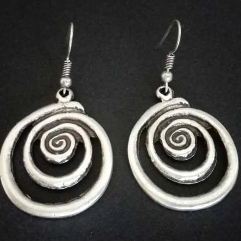 Silver geometric spiral earrings with distressed finish measuring 2.6 by 5 centimetres