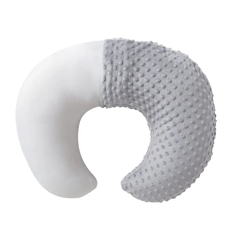 Multifunctional nursing pillow with a removable cover in grey, designed for feeding support and spill prevention.