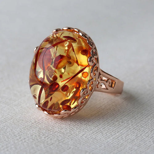 Adjustable beeswax amber ring in New Amber Type A colour on an alloy band.