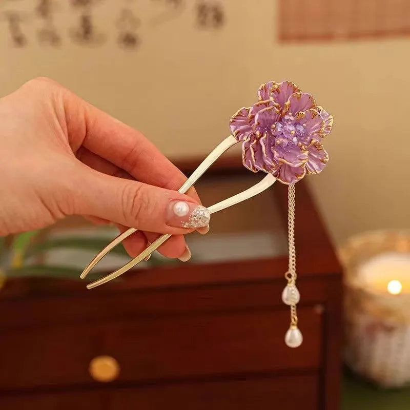 Close-up of a retro-style U-shaped alloy hairpin with a detailed peony flower and tassel design, shown in a purple electroplated finish.