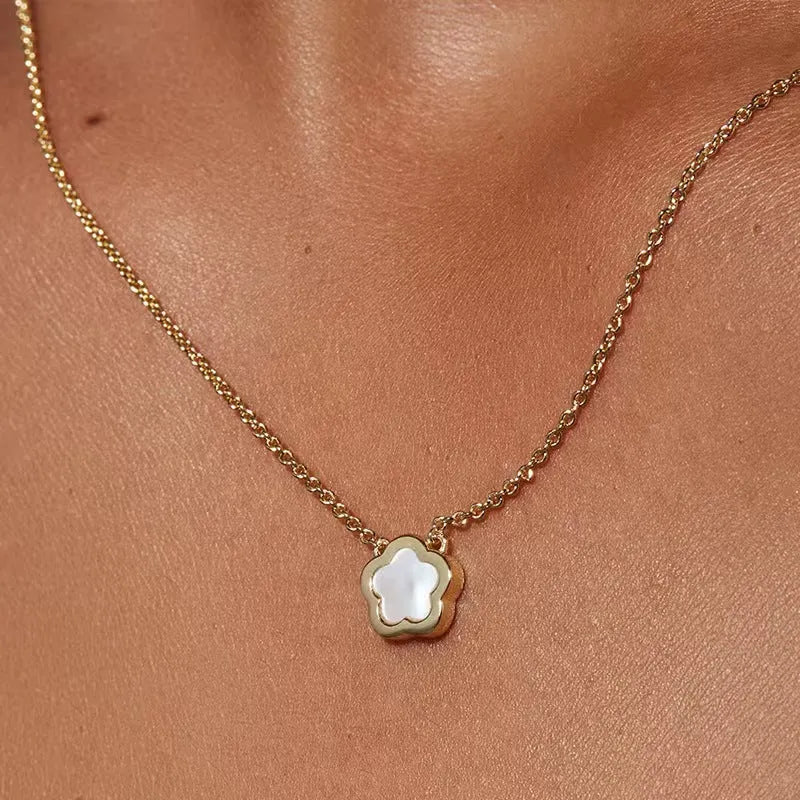 White mother of pearl flower pendant necklace on a gold-coloured chain for women.