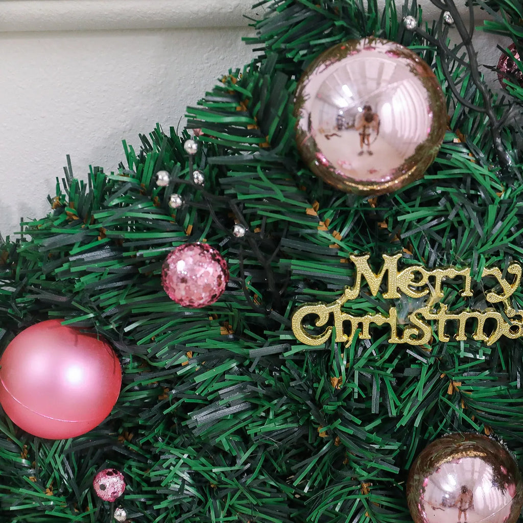 2.7 metre pink small fruit Christmas rattan garland with wrought iron frame draped along wall