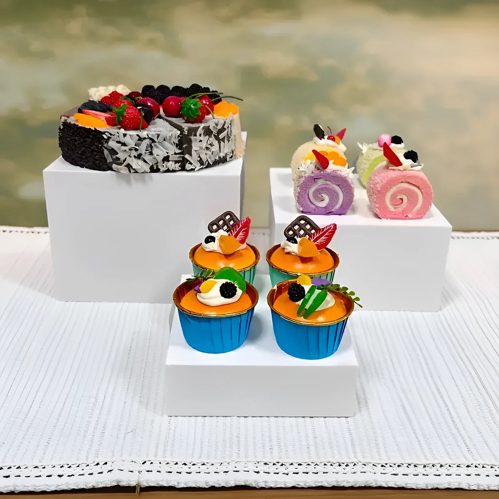 White plastic cube-style dessert display stand with six pieces for cupcakes and cakes.