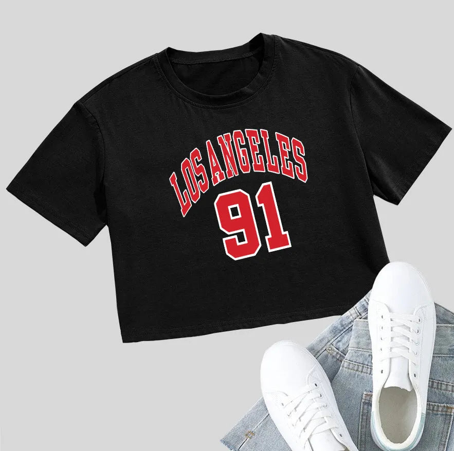 Women's black cotton t-shirt with white printed English letters, loose fit, short sleeves, and exposed navel design.