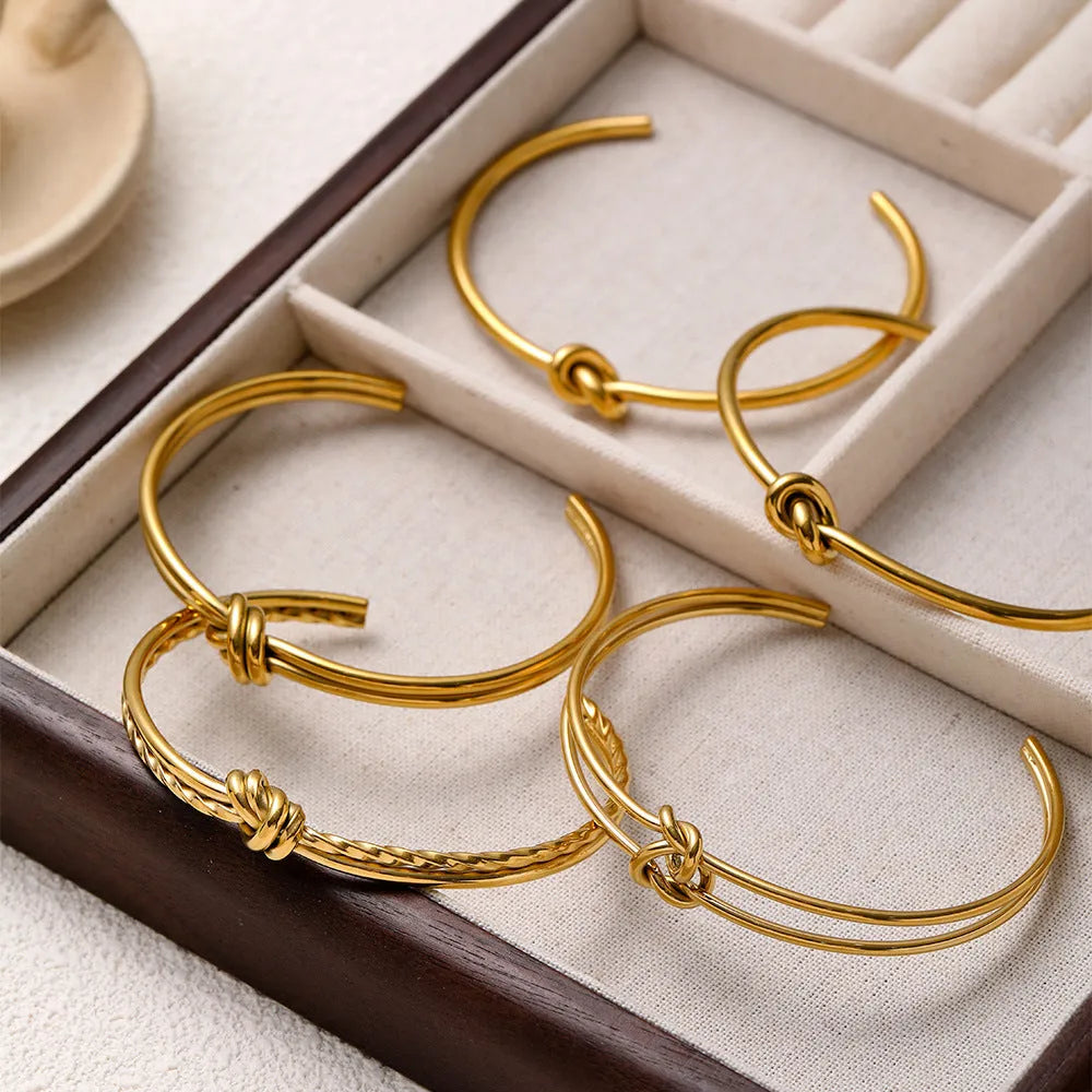 Women's stainless steel bracelet with knotted C-shaped open design in gold plating
