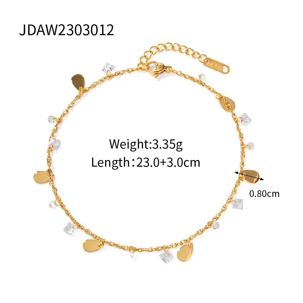 Close-up of a stainless steel geometric anklet with a personalised water drop tassel pendant.