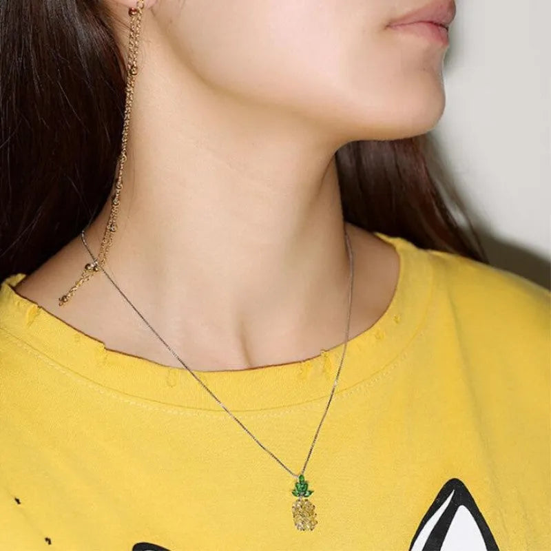 Silver geometric pineapple pendant necklace with diamond crystal details on women's model