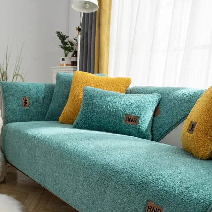 Solid colour lambswool sofa cover on a couch with matching pillow cover.