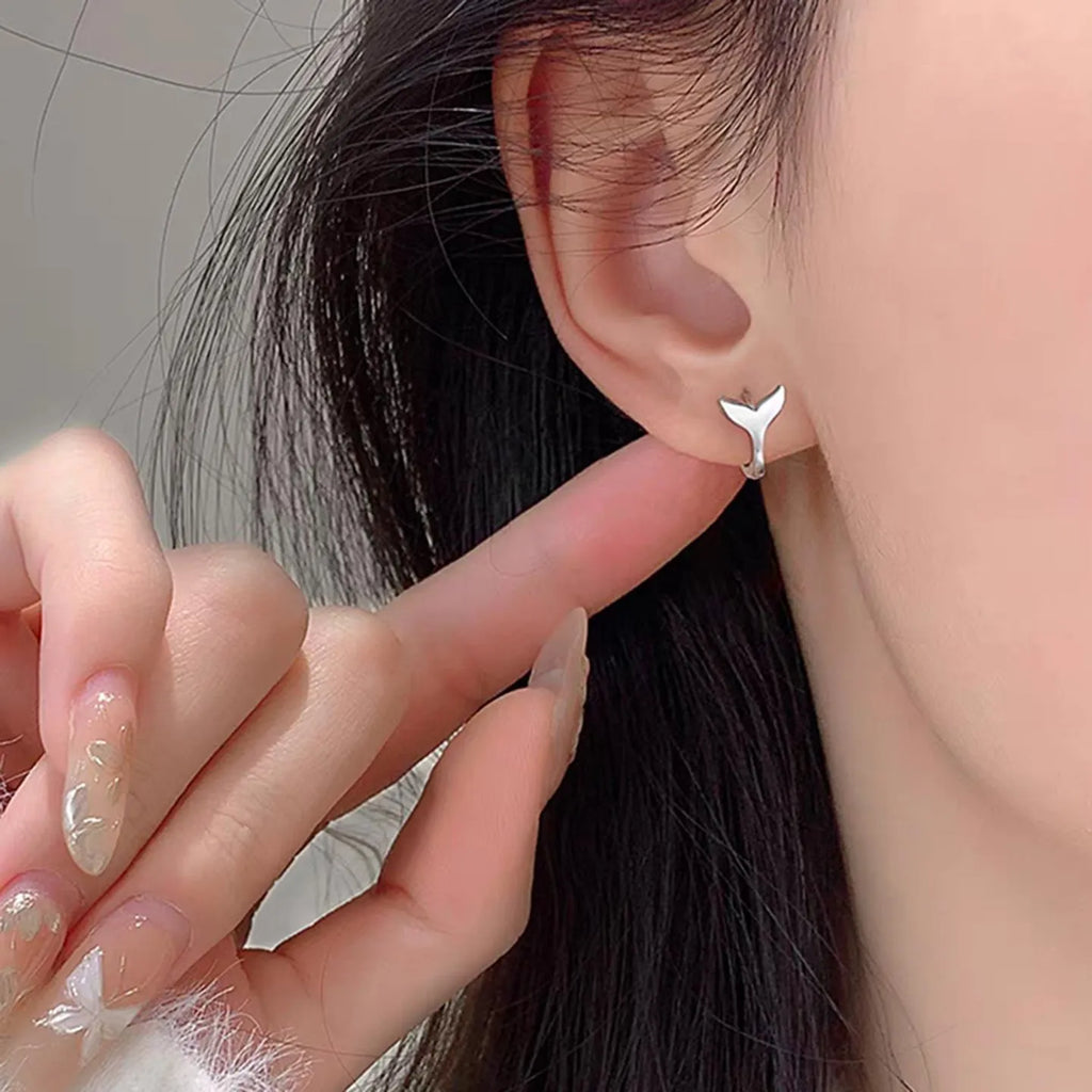 A pair of women's simple fishtail design earrings with an electroplated white gold or yellow gold finish.