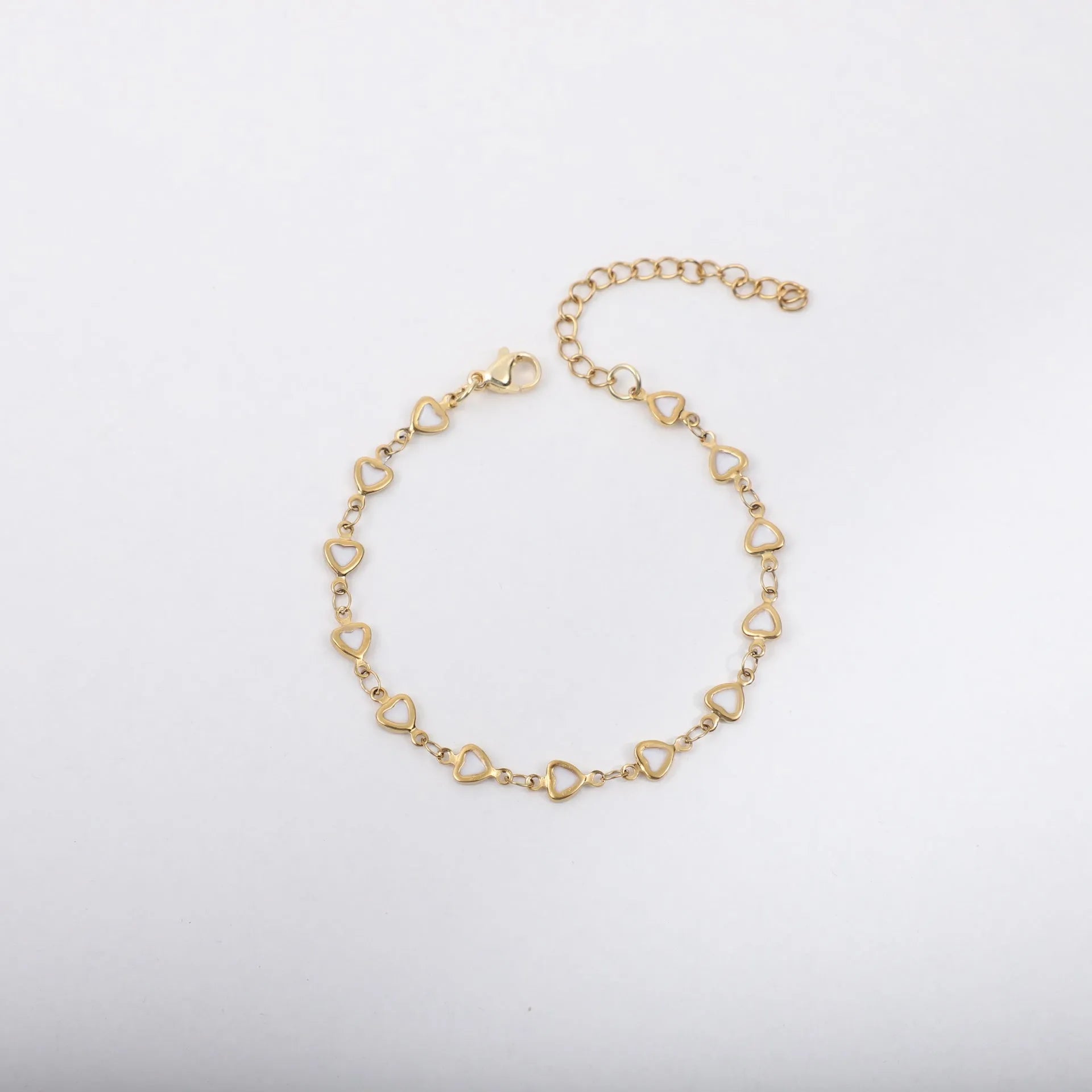 Adjustable stainless steel heart bracelet with 18K gold plating in multiple colour options showing length adjustment