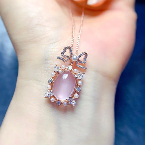 Geometric silver pendant necklace with a pink rose quartz crystal and rose gold plating.