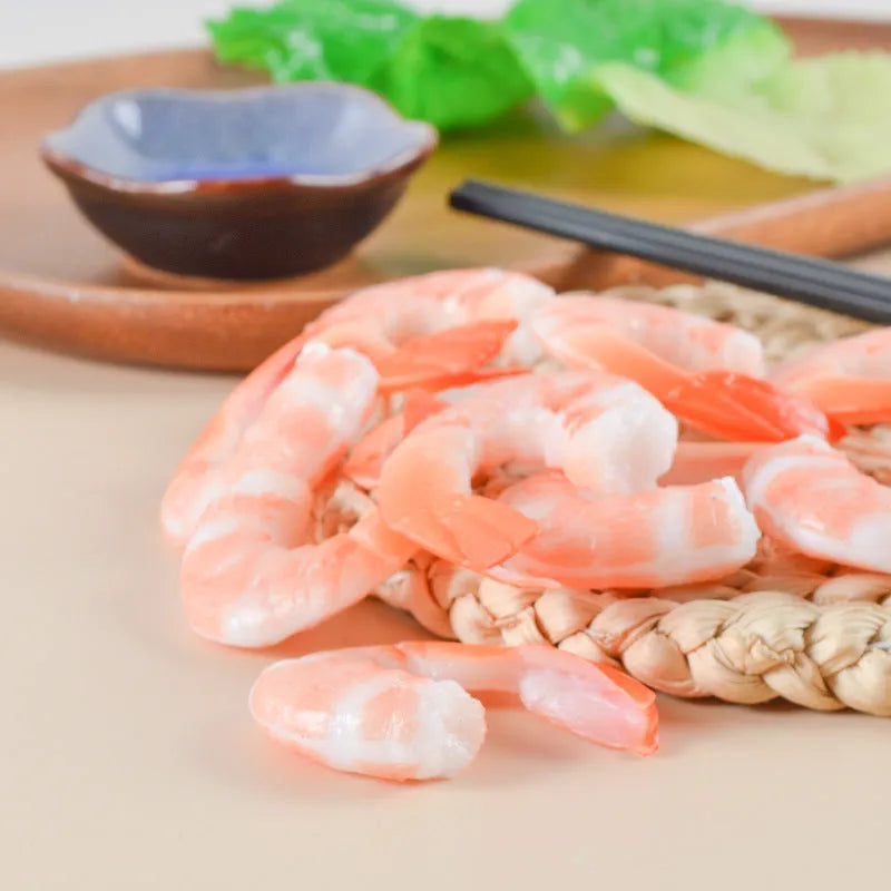 Close-up of a white simulation shrimp PVC keychain pendant showing its 1.5cm thickness.