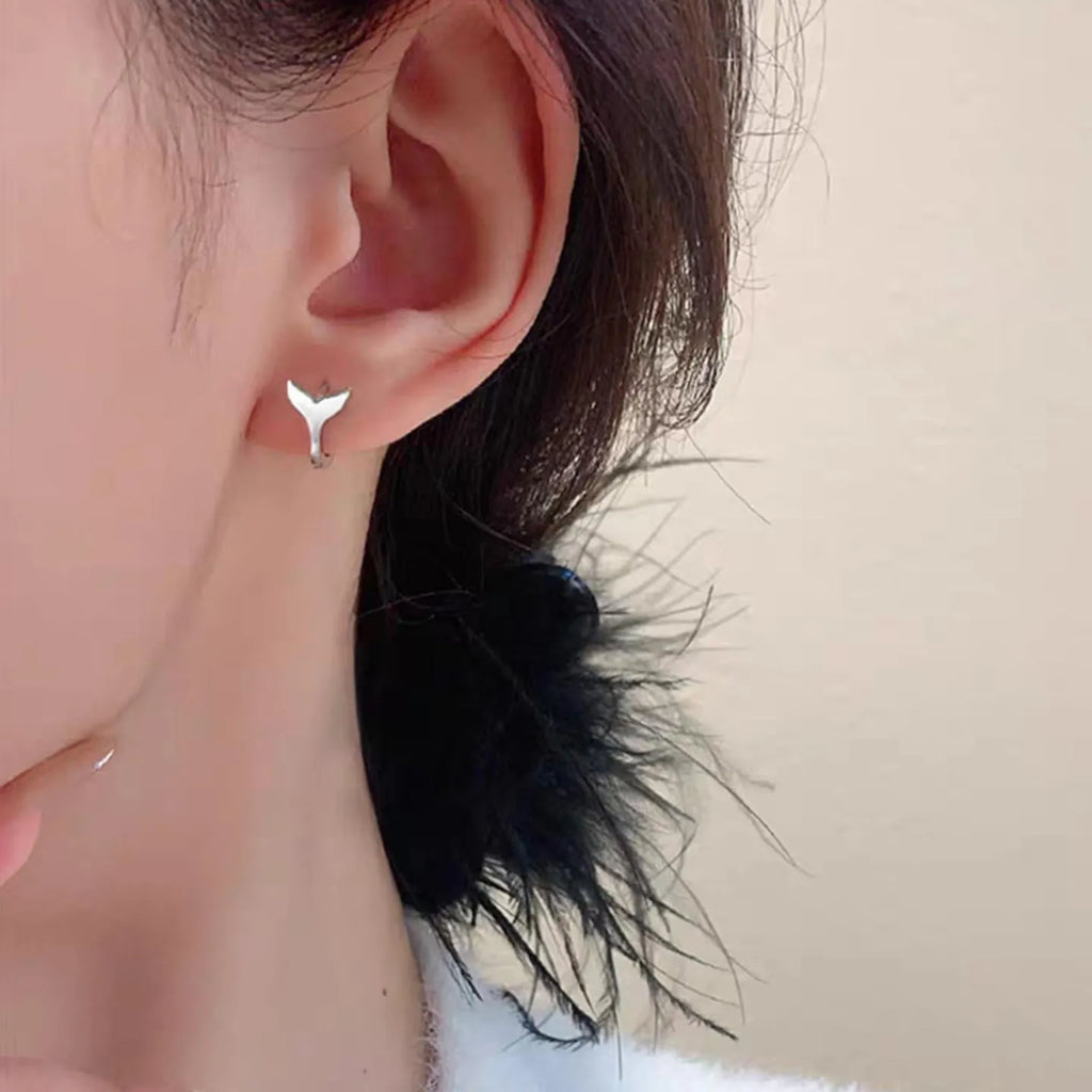 A pair of women's simple fishtail design earrings with an electroplated white gold or yellow gold finish.