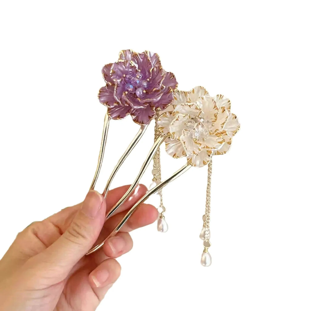 Close-up of a retro-style U-shaped alloy hairpin with a detailed peony flower and tassel design, shown in a purple electroplated finish.