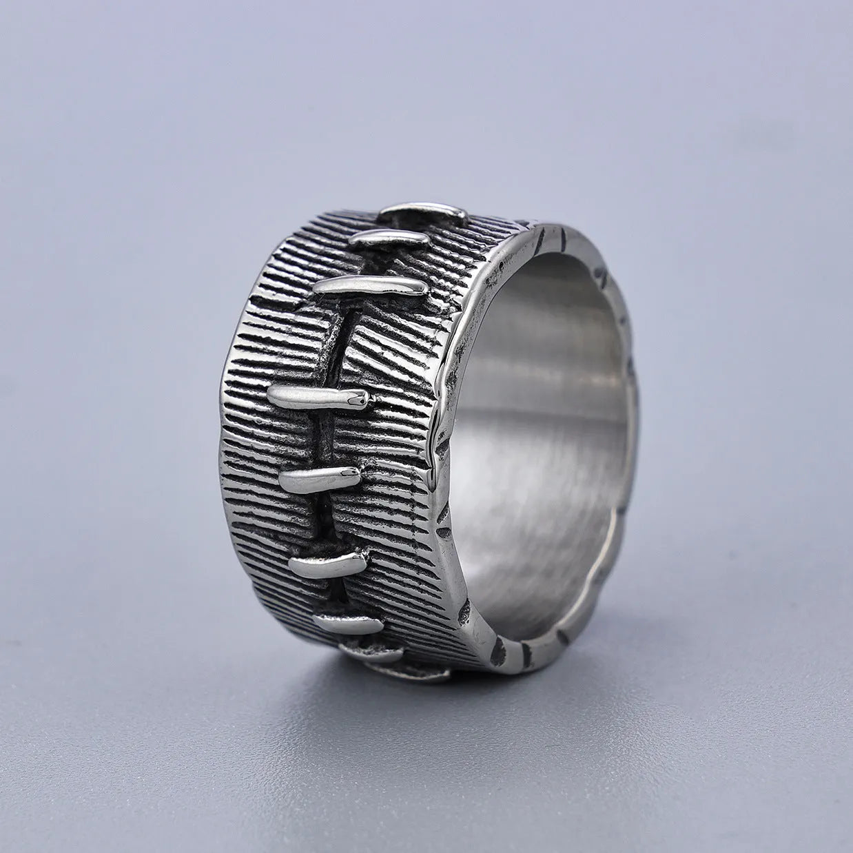 Geometric U-shaped titanium steel punk ring with double-ring design and stitched texture in black.