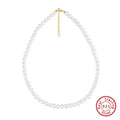 Close-up of a women's adjustable necklace with a round natural freshwater pearl on a silver chain.