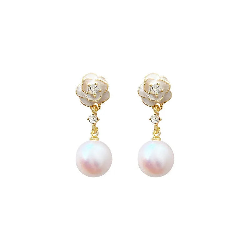 Close-up of camellia flower stud earrings for women showing alloy metal construction and floral detailing