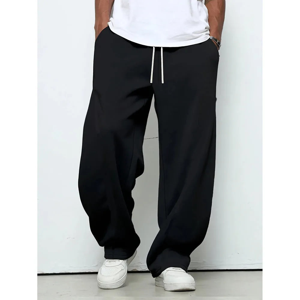Man wearing solid-colour straight-leg polyester casual trousers with a drawstring waist.