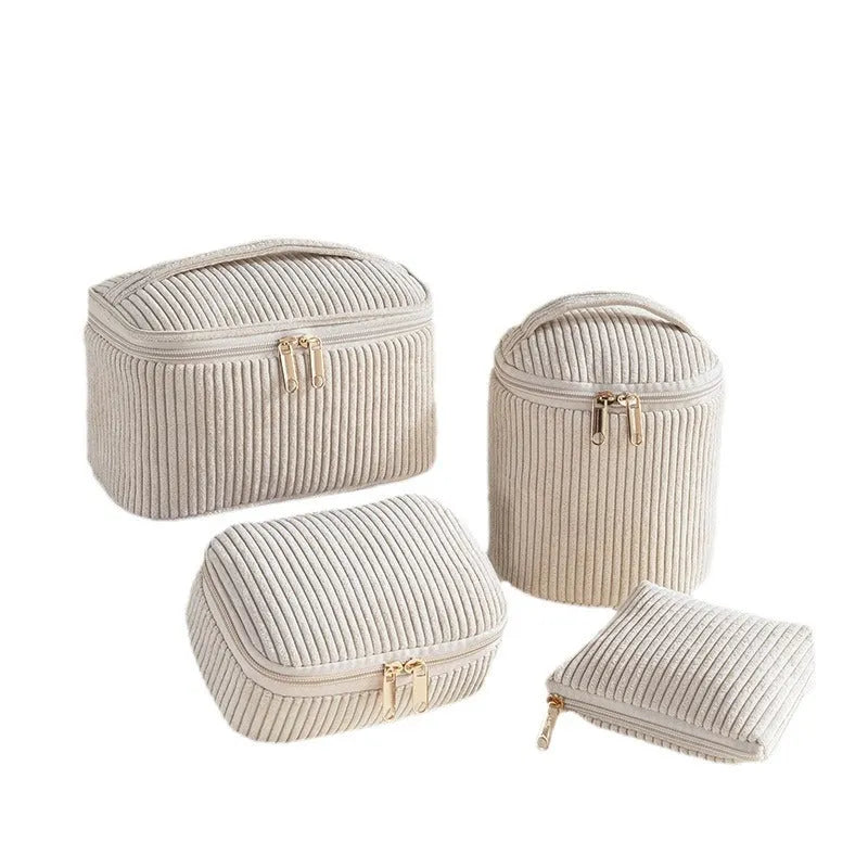 Four cube-style polyester makeup bags in blue with dots, khaki, pink, and pink dots colours arranged together