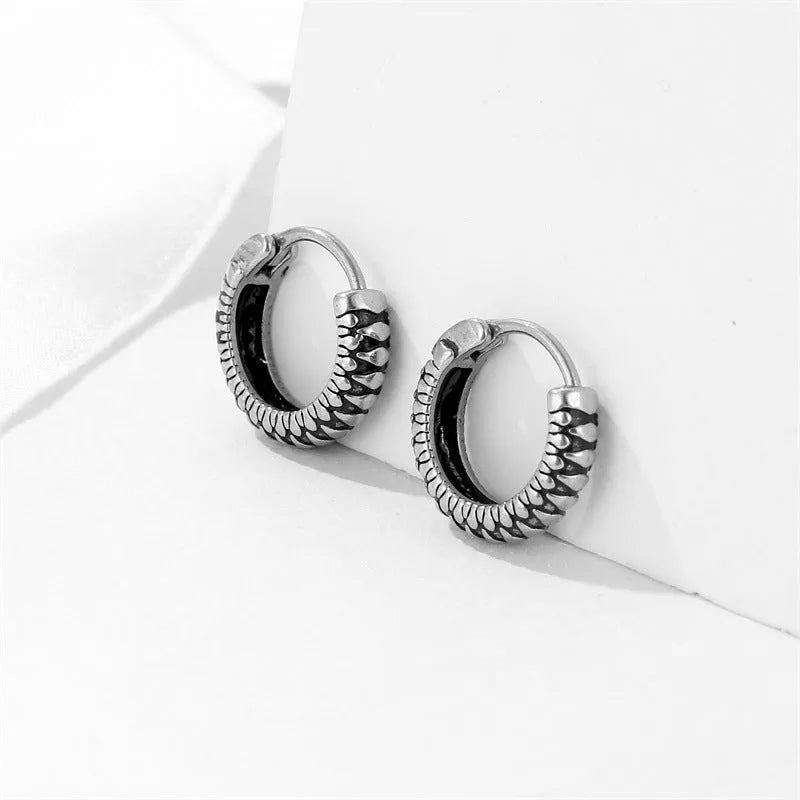 Silver geometric twist earrings with striped pattern and round sports style elements