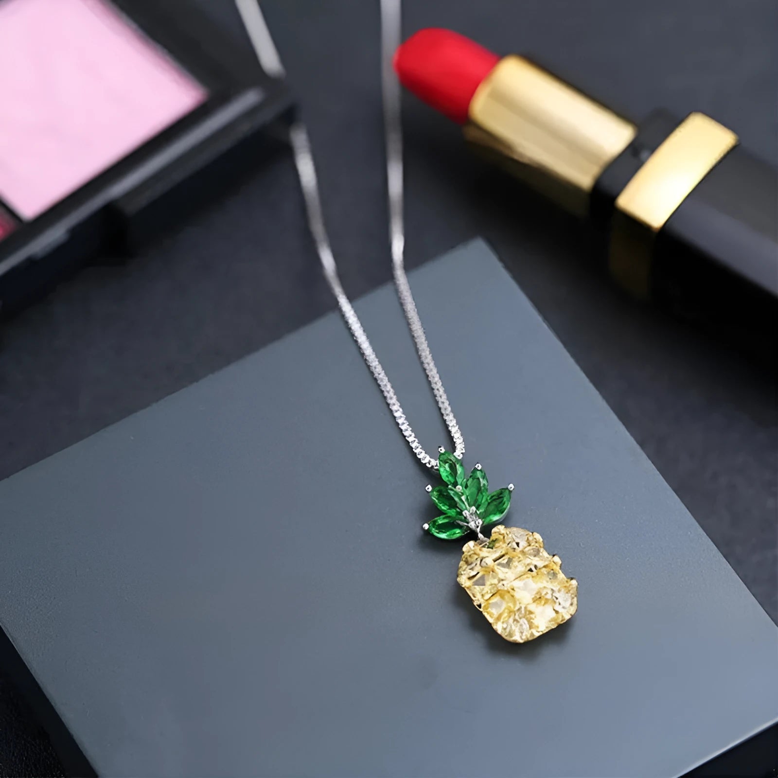 Silver geometric pineapple pendant necklace with diamond crystal details on women's model