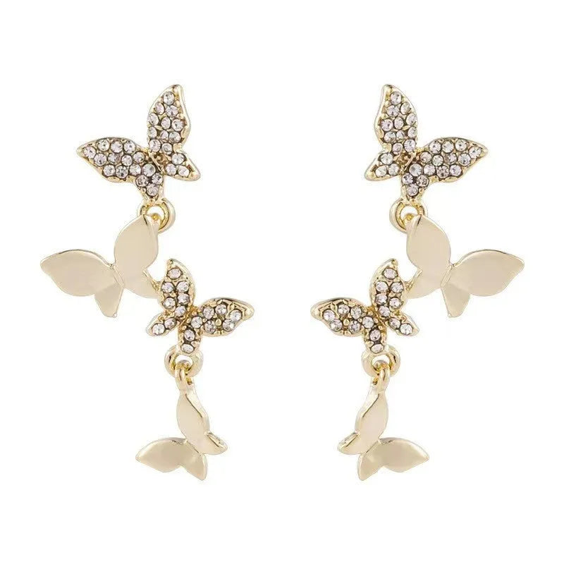 Women's butterfly drop earrings in copper with gold finish showing four butterfly design
