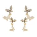 Women's butterfly drop earrings in copper with gold finish showing four butterfly design