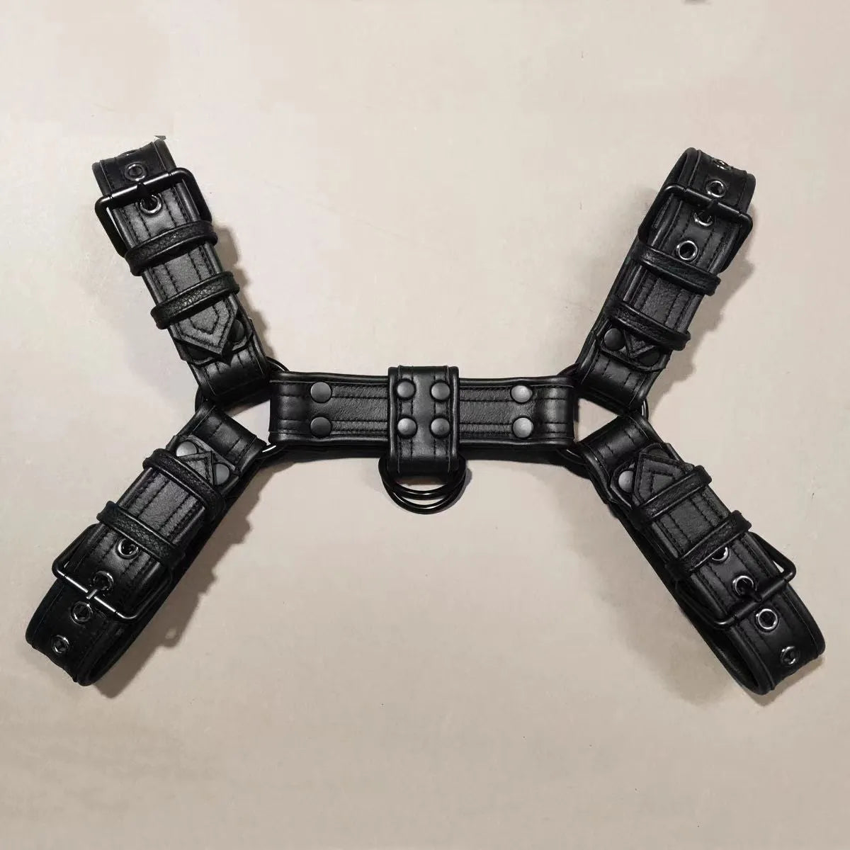 Black leather chest muscle bondage strap with metal buckle and adjustable shoulder design