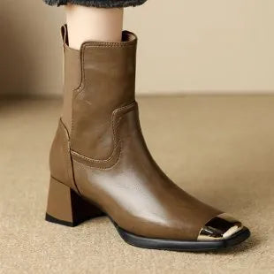 Women's brown Martin boots with high heel, side zipper, and decorative metal details on leather upper