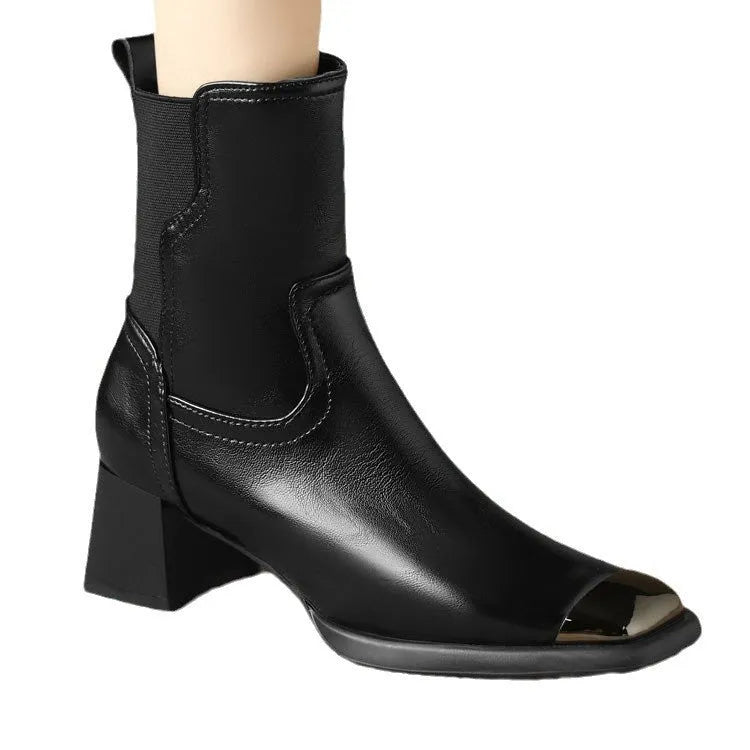 Women's brown Martin boots with high heel, side zipper, and decorative metal details on leather upper