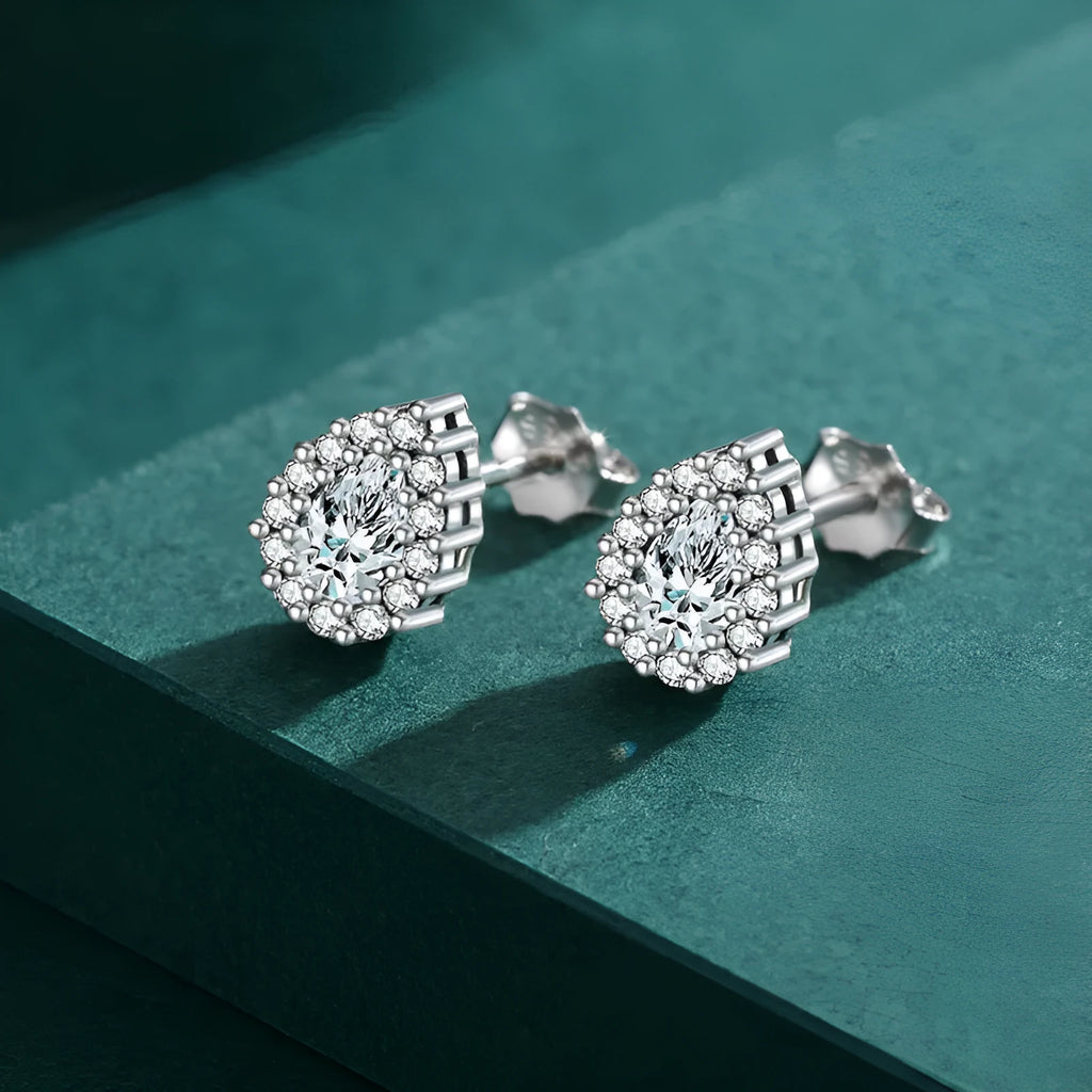 Close-up of a pair of polished silver water drop shaped ear studs on a 925 sterling silver post.