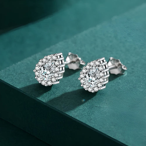 Close-up of a pair of polished silver water drop shaped ear studs on a 925 sterling silver post.