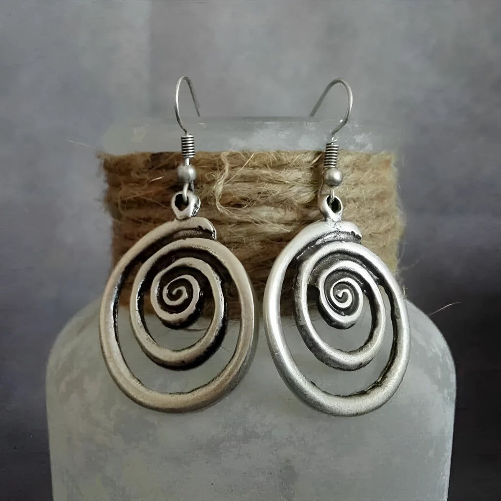 Silver geometric spiral earrings with distressed finish measuring 2.6 by 5 centimetres