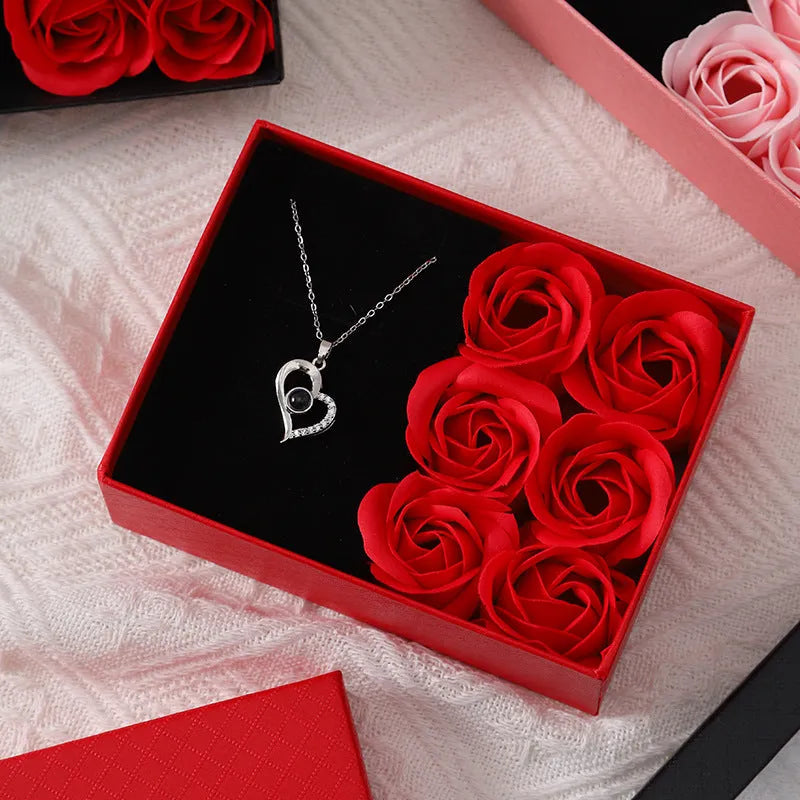 Red Korean style soap flower gift set with six roses in a box next to a matching handbag.