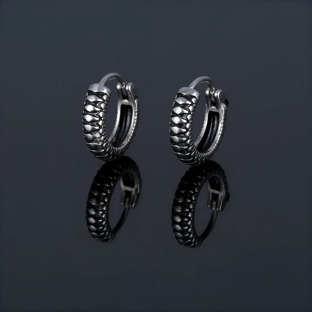 Silver geometric twist earrings with striped pattern and round sports style elements