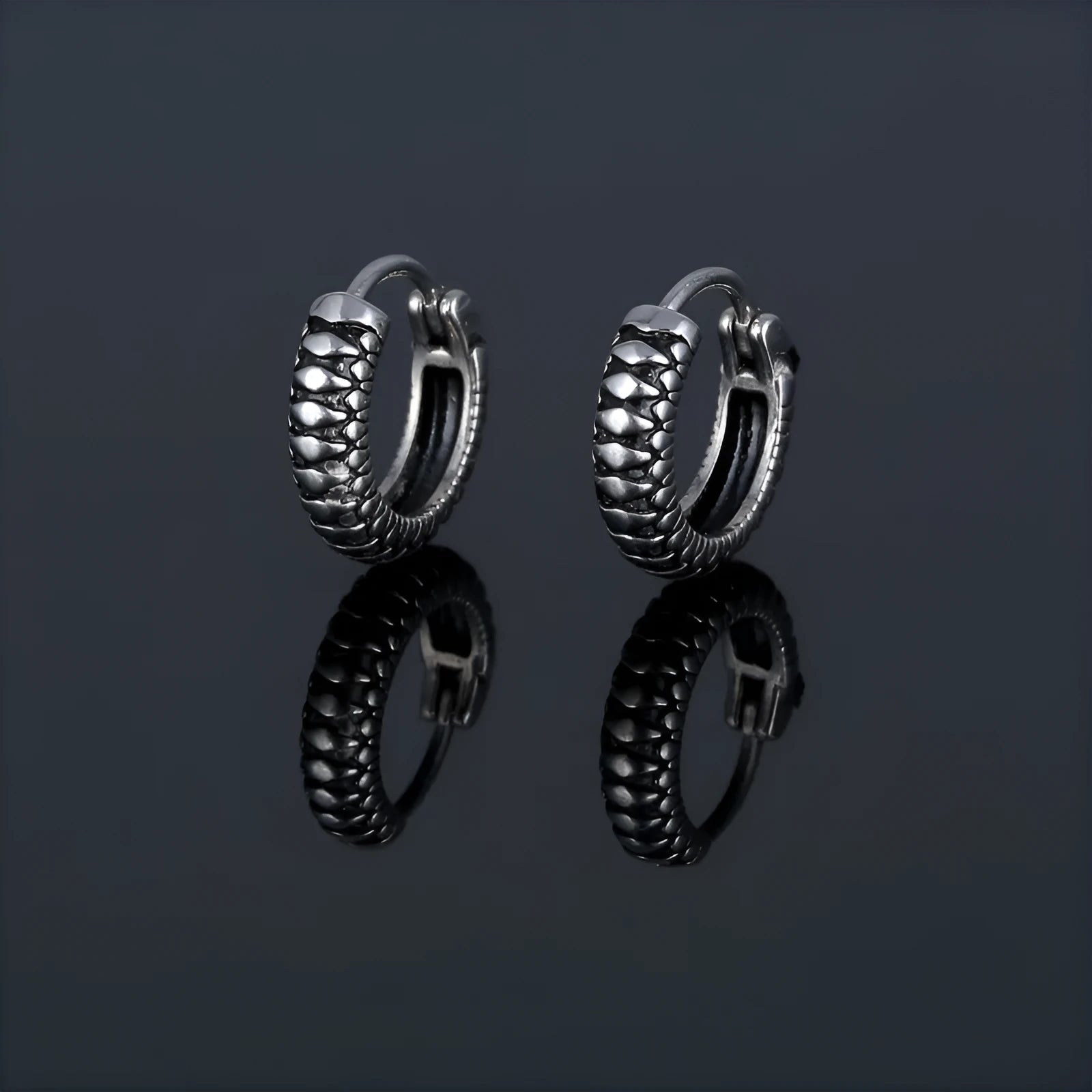 Silver geometric twist earrings with striped pattern and round sports style elements