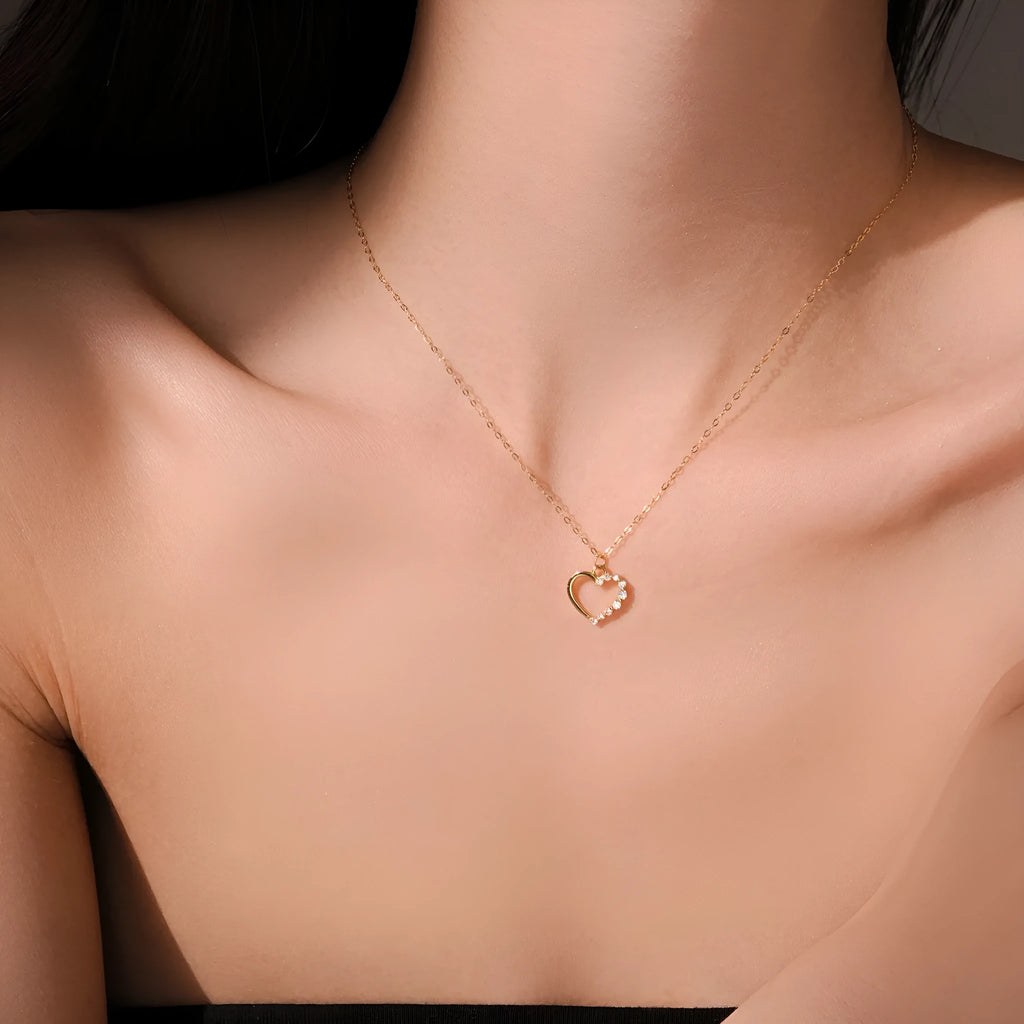 S925 sterling silver hollow heart necklace on a model, showing white gold and 18K gold plated finish options.