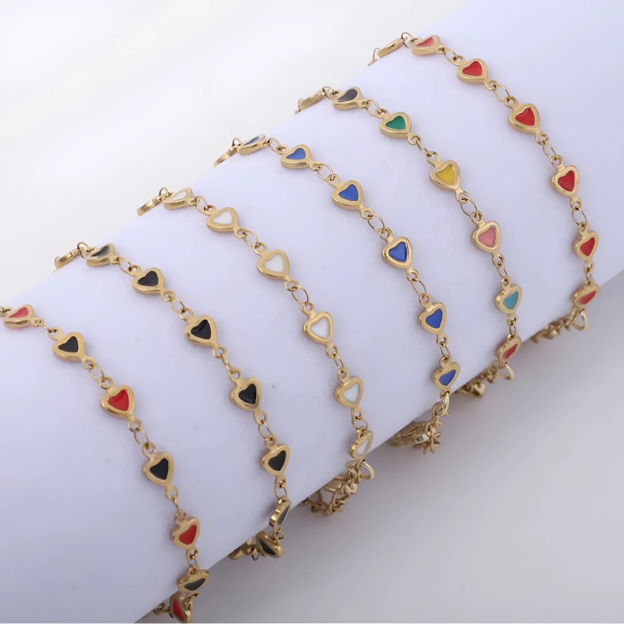 Adjustable stainless steel heart bracelet with 18K gold plating in multiple colour options showing length adjustment