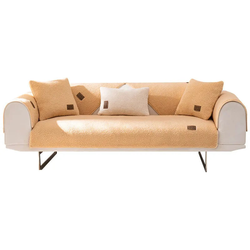 Solid colour lambswool sofa cover on a couch with matching pillow cover.