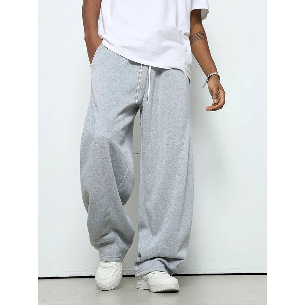 Man wearing solid-colour straight-leg polyester casual trousers with a drawstring waist.