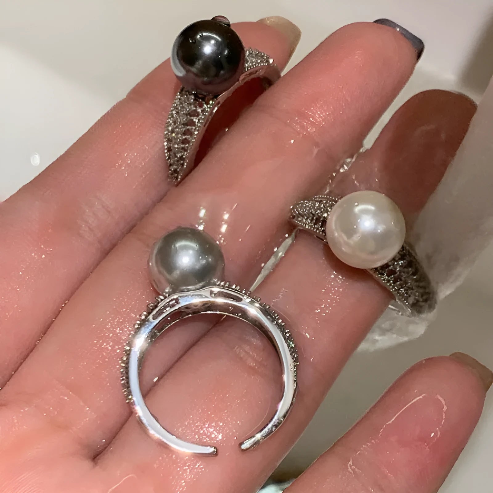 Copper geometric adjustable ring with black pearl finish on feminine hand