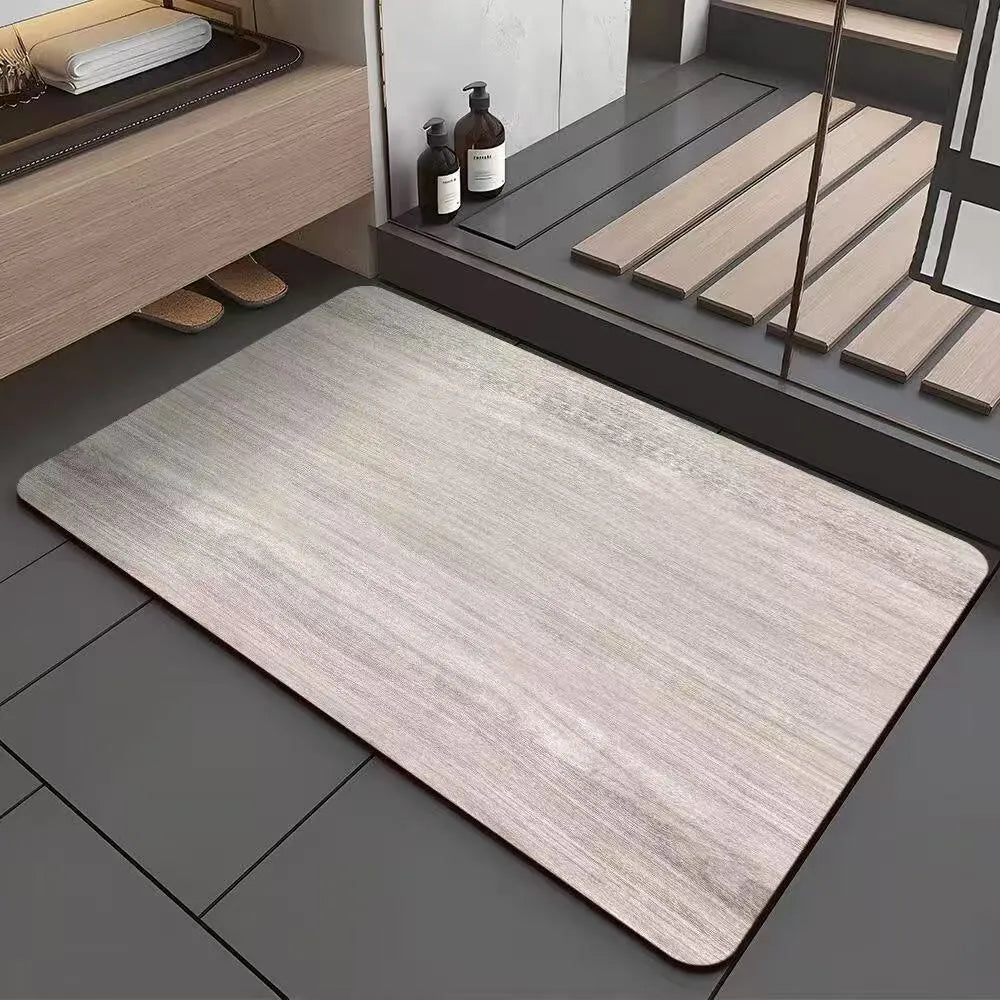 Square diatom mud bathroom floor mat with a brown wood grain geometric pattern on a tiled floor.