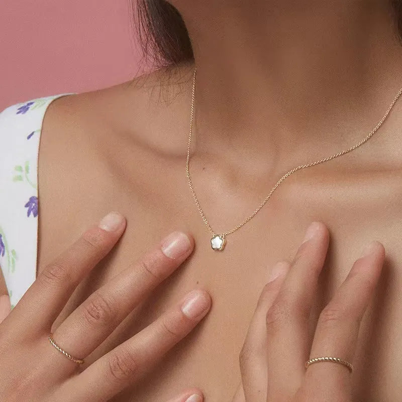 White mother of pearl flower pendant necklace on a gold-coloured chain for women.