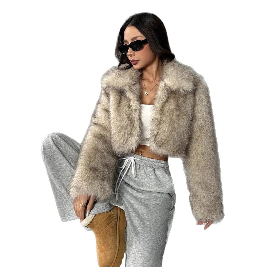 Women's short black artificial fur coat with a full fur collar and long sleeves.
