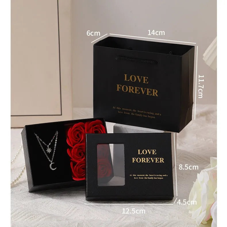 Red Korean style soap flower gift set with six roses in a box next to a matching handbag.