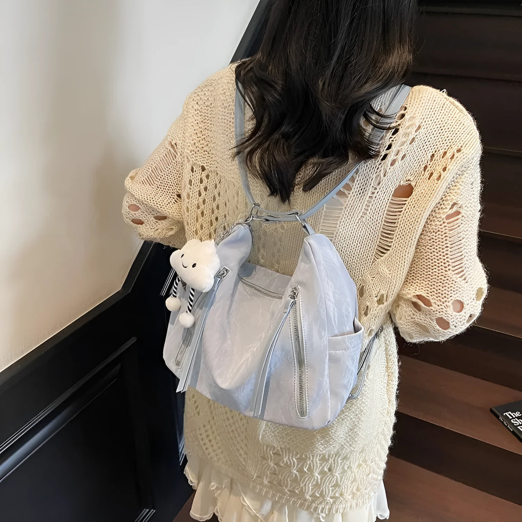 Women's soft black PU fashion backpack with adjustable straps and a silver pendant.